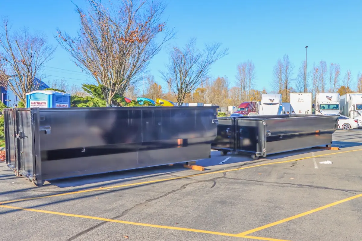 Professional dumpster rental service with roll-off container on residential driveway in Eldersburg
